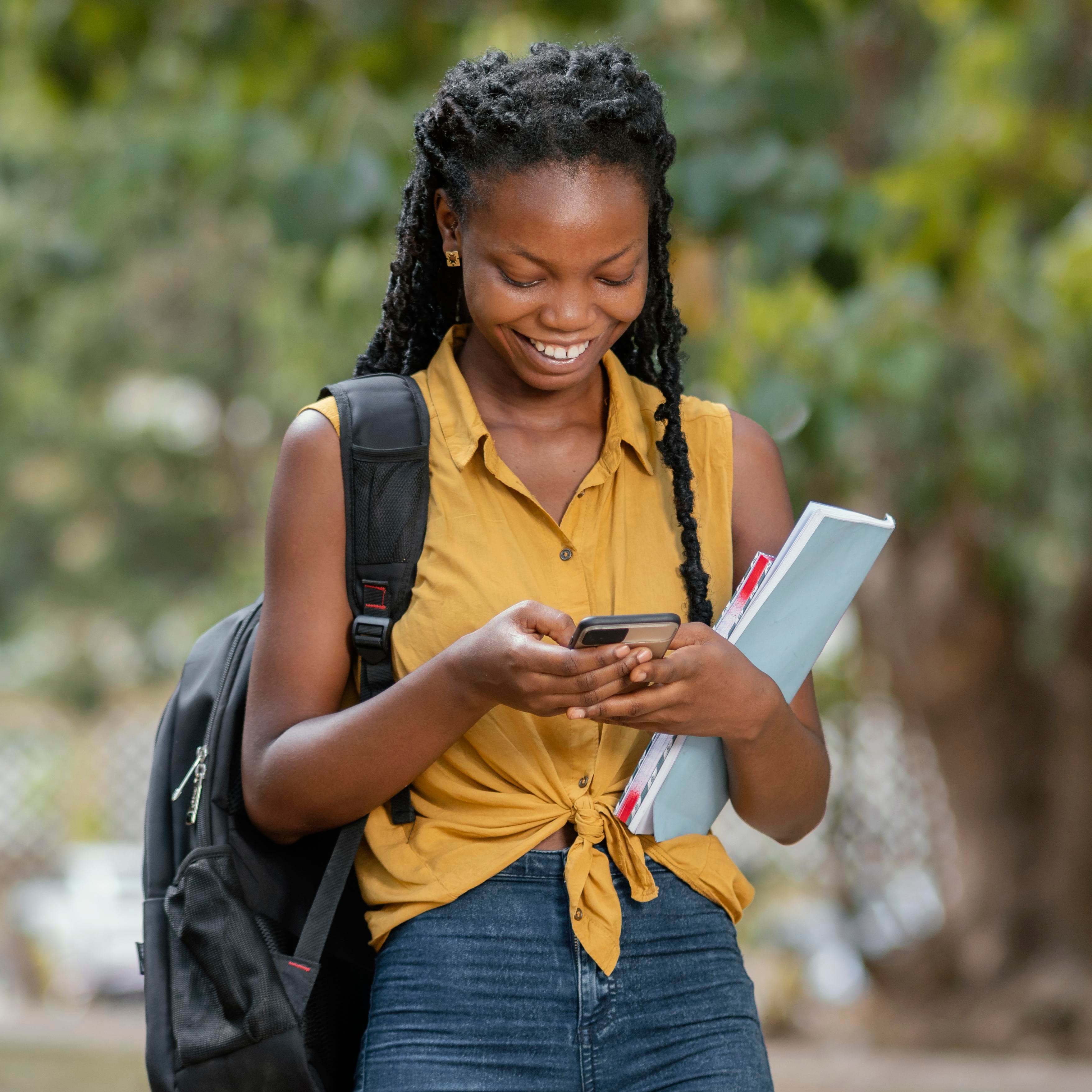 Ghanaian student using a smartphone